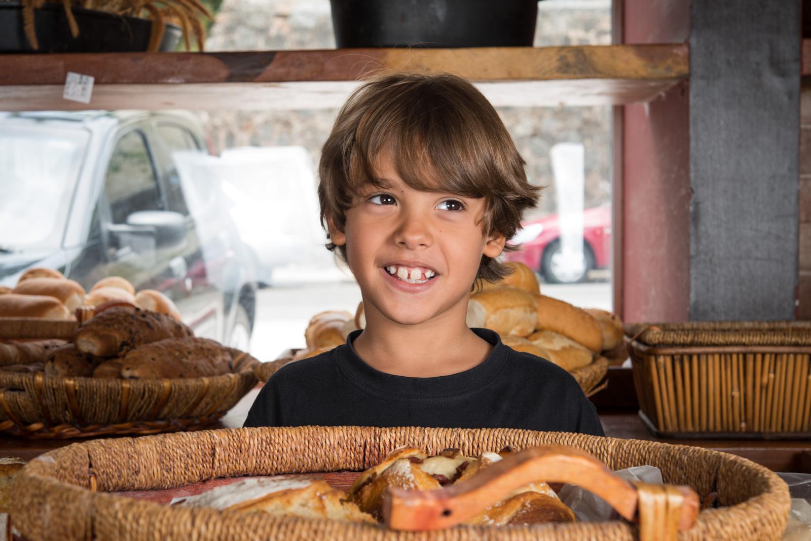 Bakery portrait — boy at bread display